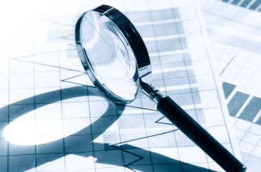 magnifying glass on paper background with chart