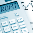 Financial chart, and calculator showing the word profit