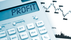 Financial chart, and calculator showing the word profit