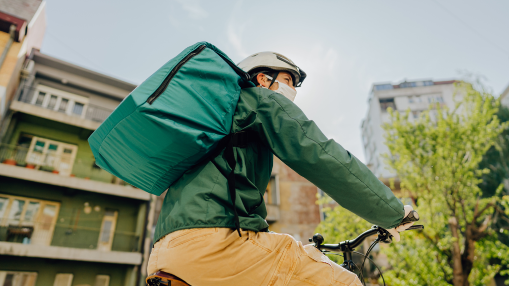 photo of a delivery man driving a bike